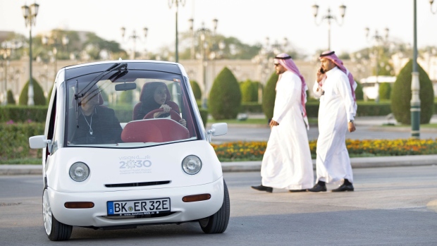 A female attendee drives a 'Vision 2030' branded electric shuttle vehicle on day two of the Future Investment Initiative (FII) forum at the Ritz Carlton hotel in Riyadh, Saudi Arabia, on Wednesday, Oct. 30, 2019. Crown Prince Mohammed bin Salman will determine the timing of oil giant Saudi Aramco’s long-anticipated share sale, according to the kingdom’s energy minister.