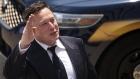 Elon Musk, chief executive officer of Tesla Inc., waves while departing court during the SolarCity trial in Wilmington, Delaware, U.S., on Tuesday, July 13, 2021. Musk was cool but combative as he testified in a Delaware courtroom that Tesla's more than $2 billion acquisition of SolarCity in 2016 wasn't a bailout of the struggling solar provider. Photographer: Al Drago/Bloomberg