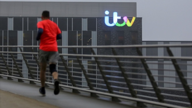 A runner heads over a footbridge in MediaCity in view of the ITV Plc studio building in Salford, near Manchester, U.K., on Wednesday, Feb. 5, 2020. U.K. Prime Minster Boris Johnson has spoken repeatedly about "leveling up" across the U.K. and the budget due in March is expected to include billions of pounds of new infrastructure projects to boost the economy of northern England, which has been hit by a decade of austerity and the decline of heavy industry.