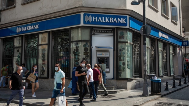 Pedestrians pass a bank branch of Turkiye Halk Bankasi AS in the Sirkeci neighborhood of Istanbul, Turkey, on Thursday, Aug. 27, 2020. Economic activity fell faster and deeper in emerging markets than in advanced economies as the Covid-19 shock hit, and the recovery is proving slower and shallower. Photographer: Nicole Tung/Bloomberg