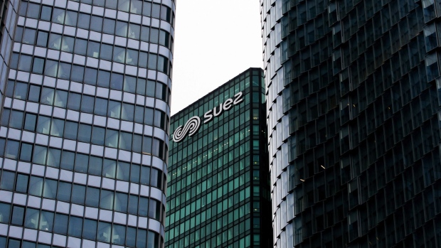 The Suez SA logo sits on the company's headquarter offices in the La Defense business district in Paris, France, on Monday, Sept. 28, 2020. Veolia Environnement SA Chief Executive Officer Antoine Frerot confirmed he would deliver a sweetened bid to Engie SA for most of its shares in French waste and water group Suez SA ahead of a Wednesday deadline, rejecting any extension. Photographer: Nathan Laine/Bloomberg