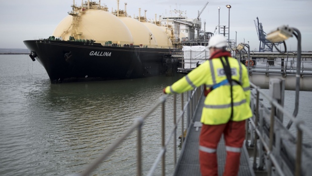 An employee looks towards the Gallina liquefied natural gas (LNG) tanker after docking at the National Grid Plc's Grain LNG plant on the Isle of Grain in Rochester, U.K., on Saturday, March 4, 2017. The shipment to England on the Gallina was priced using the U.K.'s National Balancing Point, where front-month gas cost about $7 a million British thermal units on Feb. 7. Photographer: Jason Alden/Bloomberg