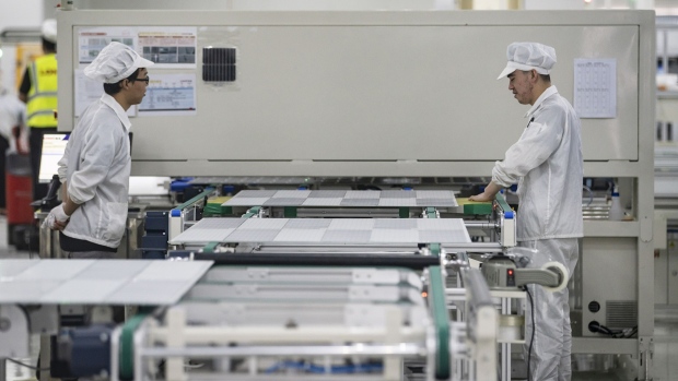 Employees manufacture photovoltaic modules at the Longi Green Energy Technology Co. solar panel fact