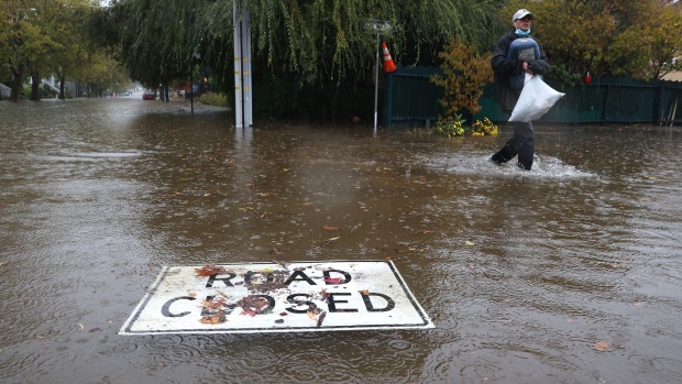 A road closed sign floats on a flooded street on October 24, 2021 in San Rafael, California. 