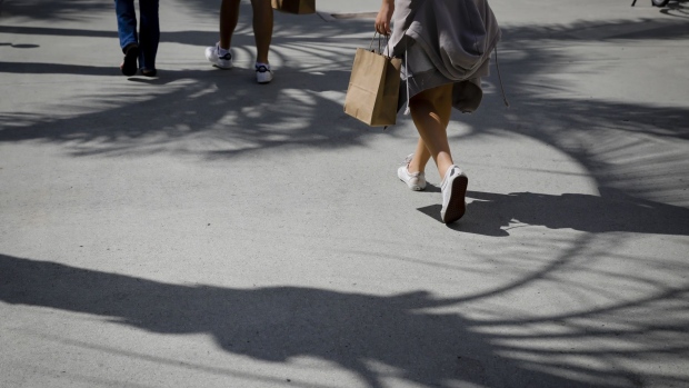 A pedestrian carries a shopping bag while walking in Miami, Florida, U.S., on Saturday, Oct. 23, 2021. Consumers are facing dire warnings to get their holiday shopping done early this year, especially if they’re planning to do it online. Bottlenecks in the global supply chain are posing a new challenge to the e-commerce industry, and out-of-stock items represent a growing concern. Photographer: Eva Marie Uzcategui/Bloomberg