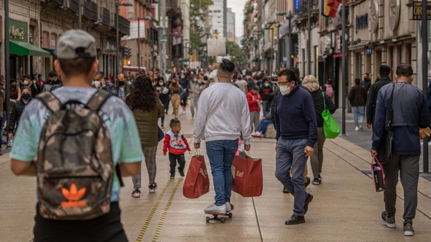 A person rides a skateboard while carrying shopping bags in Mexico City, Mexico, on Wednesday, Nov. 18, 2020. The number of confirmed cases in the coronavirus outbreak in Mexico stands at 1.02 million as of 7:30am on November 19 in Mexico City, according to data collected by Johns Hopkins University and Bloomberg News.