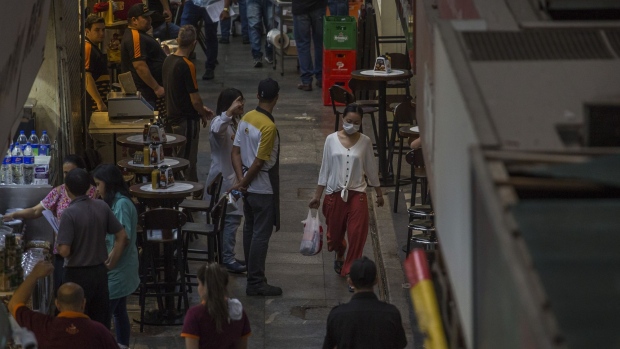 A shopper wearing a protective mask walks through the Municipal Market in Sao Paulo.