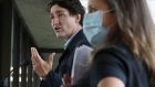 Justin Trudeau speaks beside Chrystia Freeland during an Ottawa news conference on Oct. 21.