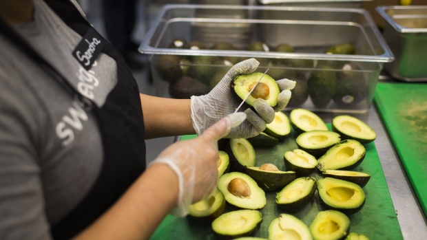 A worker prepares avocados inside a Sweetgreen Inc. restaurant in Boston, Massachusetts, U.S., on Tuesday, Oct. 24, 2017. The fast casual dining chain Sweetgreen was founded in 2007 by three classmates from Georgetown University, and has expanded from its Washington roots to more than 80 locations nationally. Photographer: Adam Glanzman/Bloomberg