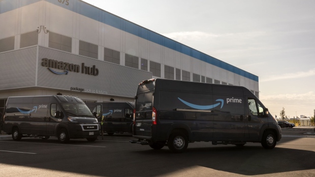 Delivery vans exit from at an Amazon fulfillment center in Denver, Colorado, U.S., on Tuesday, Sept. 28, 2021. Three years ago, Amazon.com Inc. issued an invitation that seemed too good to pass