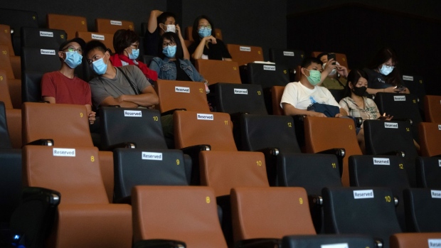 Customers wearing protective masks sit apart in observance of social distancing measures inside a theater at the K11 Art House cinema operated by UA Cinema Circuit Ltd. in Hong Kong, China, on Friday, May 8, 2020. Hong Kong leader Carrie Lam moved to loosen curbs on social gatherings and reopen shuttered schools, as a lull in coronavirus infections set the stage for fresh political battles over the future of the Asian financial hub. Photographer: Roy Liu/Bloomberg