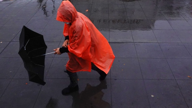 NEW YORK, NEW YORK - OCTOBER 26: A person wearing a rain poncho struggles with their umbrella during an autumn Nor'easter on October 26, 2021 in the Brooklyn borough of New York City. New York and New Jersey declared states of emergency as the storm brought heavy rain and strong winds to the area, with up to 3 inches of rain in some parts of the city. A flash flood watch is in effect in NYC until 6 P.M. tonight. (Photo by Michael M. Santiago/Getty Images)
