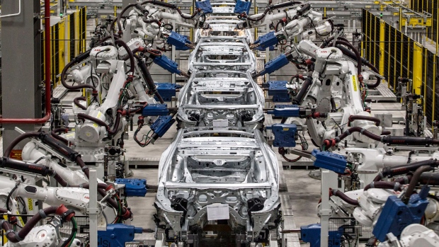 Robotic arms work on the body frames of Vinfast Lux A2.0 sedans in the body shop area of the automaker's factory in Haiphong, Vietnam.