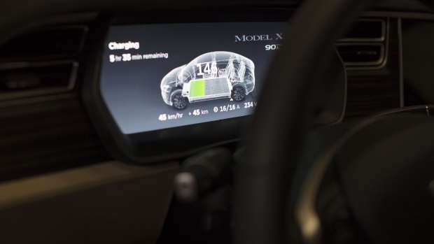 Battery charging status information is displayed on a dashboard screen inside a Tesla Model X sports utility vehicle (SUV) during assembly for the European market at the Tesla Motors Inc. factory in Tilburg, Netherlands, on Friday, Dec. 9, 2016. A boom in electric vehicles made by the likes of Tesla could erode as much as 10 percent of global gasoline demand by 2035, according to the oil industry consultant Wood Mackenzie Ltd. Photographer: Jasper Juinen/Bloomberg