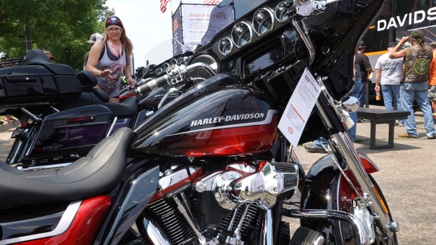 STURGIS, SOUTH DAKOTA - AUGUST 08: People look over new motorcycles at the Harley-Davidson exhibit at the 81st annual Sturgis Motorcycle Rally on August 8, 2021 in Sturgis, South Dakota. The rally is expect to draw more than 500,00 people during its 10-day run. (Photo by Scott Olson/Getty Images)
