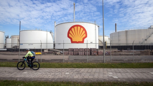 A cyclist passes oil silos at the Royal Dutch Shell Plc Pernis refinery in Rotterdam, Netherlands, on Tuesday, April 27, 2021. Shell reports first quarter earnings on April 29.