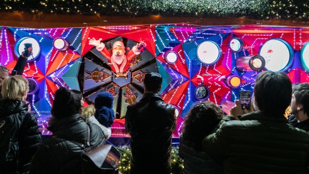 Pedestrians view a Macy's Inc. holiday window display during an unveiling event in New York.