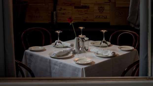 An empty dining table in the outdoor area of a restaurant in the Greenwich Village neighborhood of New York. Photographer: Amir Hamja/Bloomberg