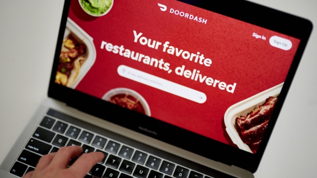 A DoorDash Inc. delivery person holds an insulated bag at Chef Geoff's restaurant in Washington, D.C., U.S., on Thursday, March 26, 2020. As the wheels of government turn too slowly for small businesses desperate for a piece of the $2 trillion U.S. relief package due to the coronavirus pandemic, restaurateur Geoff Tracy is using GoFundMe to raise money for 150 hourly workers at his American comfort food standby Chef Geoff's and other restaurants. Photographer: Andrew Harrer/Bloomberg
