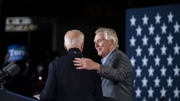 Joe Biden greets Terry McAuliffe during a campaign event in Arlington, Virginia, on Oct. 26. Photographer: Al Drago/Bloomberg