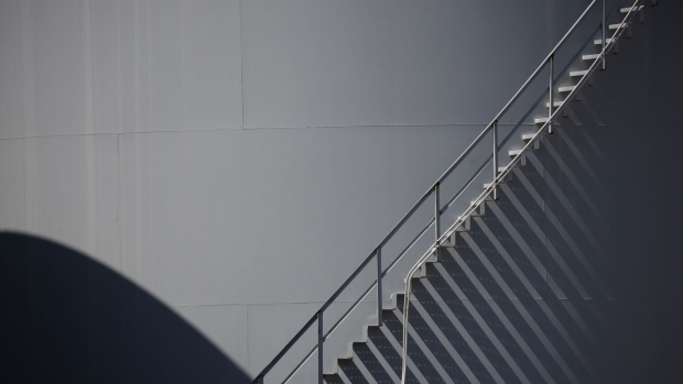 A staircase ascends a storage tank located near a dock for Hornbeck Offshore Services, Inc. oil industry support vessels in Port Fourchon, Louisiana, U.S., on Thursday, June 11, 2020. Oil eclipsed $40 a barrel in New York on Friday, extending a slow but relentless rise that’s been fueled by a pick-up in demand and could signal a reawakening for U.S. shale production. Photographer: Luke Sharrett/Bloomberg