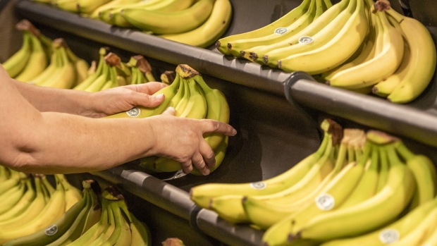 A customer picks a bunch of sustainably sourced bananas inside an Asda store, trialing new sustainability initiatives, in Middleton, U.K., on Thursday, Oct. 29, 2020. Walmart Inc. is pulling out of the cutthroat U.K. grocery market after 21 years, agreeing to sell control of grocer Asda to TDR Capital and two brothers who made their wealth in gas stations. Photographer: Anthony Devlin/Bloomberg