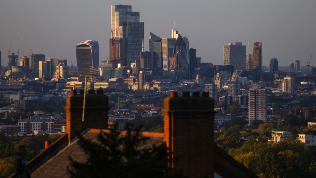 Skyscrapers and buildings above residential houses on the City of London skyline at dusk in London, U.K., on Thursday, Oct. 21, 2021. U.K. Prime Minister Boris Johnson said the City of London will prosper outside the European Union, noting job losses and disruption to capital flows have been lower than feared. Photographer: Chris Ratcliffe/Bloomberg