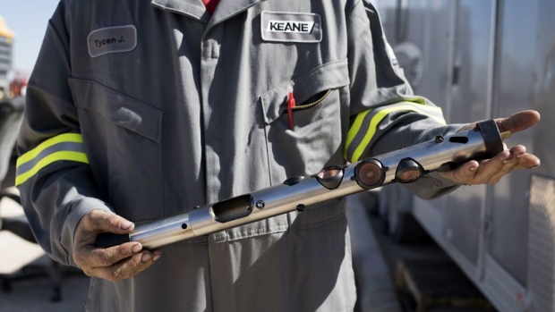 A worker displays a hydraulic fracturing perforating gun, used to penetrate the shale rock underground, for a photograph at a Royal Dutch Shell Plc hydraulic fracking site near Mentone, Texas, U.S., on Thursday, March 2, 2017. Exxon Mobil Corp., Royal Dutch Shell and Chevron Corp., are jumping into American shale with gusto, planning to spend a combined $10 billion this year, up from next to nothing only a few years ago. Photographer: Bloomberg/Bloomberg