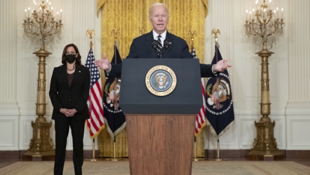 U.S. President Joe Biden arrives to speak in the East Room of the White House with Vice President Kamala Harris, right, in Washington, D.C., U.S., on Thursday, Oct. 28, 2021. Biden unveiled a framework for a $1.75 trillion tax and spending package his administration believes can pass Congress and urged House Democrats to quickly clear a separate public works bill for his signature, despite misgivings by progressives. Photographer: Tom Brenner/Bloomberg