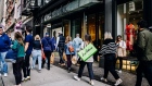 Pedestrians carrying shopping bags in the SoHo neighborhood of New York. Photographer: Nina Westervelt/Bloomberg