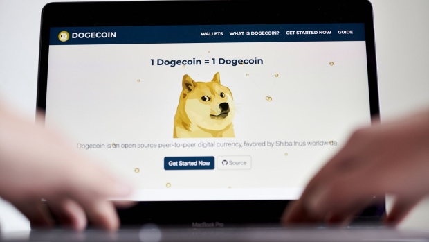 The Dogecoin website on a laptop computer arranged in the Brooklyn borough of New York, U.S., on Friday, May 7, 2021. Dogecoin, a cryptocurrency conceived as a joke but now the world's fifth-most valuable, plunged from an all-time high after its most famous cheerleader, Elon Musk, jokingly called it "a hustle" on late-night TV.