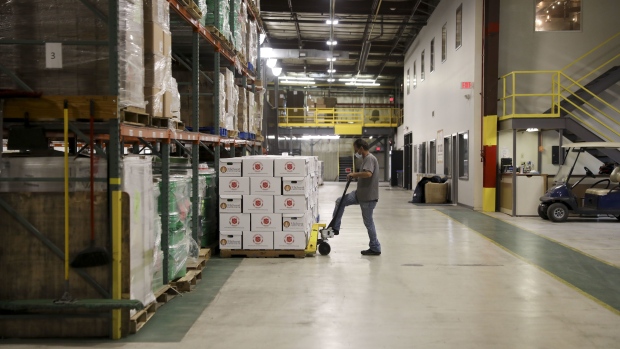 A volunteer moves a pallet of Family Food Boxes at a Midwest Food Bank distribution warehouse in Normal, Illinois, U.S., on Wednesday, May 13, 2020. The coronavirus pandemic is forcing food banks across the country to find new ways to feed people — from slaughtering animals to enlisting car dealerships and unemployed restaurant workers to serve homebound clients. Photographer: Daniel Acker/Bloomberg