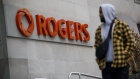 A pedestrian passes Rogers Communications headquarters in Toronto on Oct. 22.