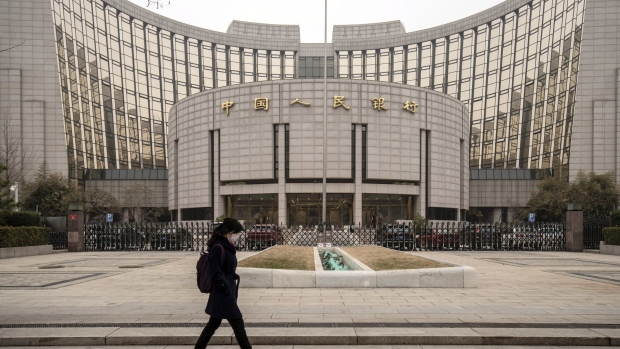 A pedestrian walks past the People's Bank of China (PBOC) building in Beijing, China, on Thursday, March 4, 2021. The low cost of borrowing in China’s money markets suggests the central bank again has room to tighten policy by withdrawing liquidity from the financial system -- like it did in January. Photographer: Qilai Shen/Bloomberg