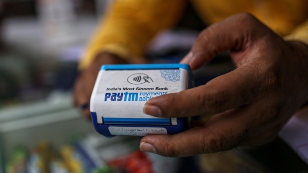 A storekeeper uses a Paytm All-In-One POS payment device arranged at a medical store in Mumbai, India, on Saturday, July 17, 2021. Paytm, the Indian digital payments pioneer backed by SoftBank Group Corp., is seeking approval for a $2.2 billion initial public offering that could be India's largest. Photographer: Dhiraj Singh/Bloomberg