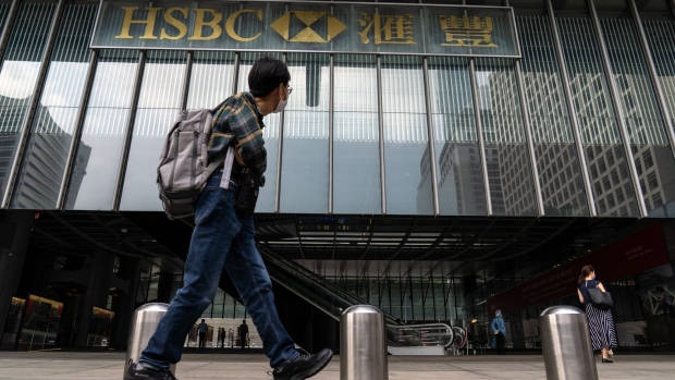 A pedestrian walks past the HSBC Holdings Plc headquarters building, temporary closed due to the coronavirus, in Hong Kong, China, on Wednesday, March 17, 2021. HSBC's main Hong Kong office was closed until further notice after three people working in the building tested positive for Covid-19 amid a renewed wave of infections among the city’s business and expatriate community.