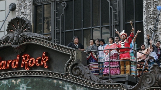Members of the Seminole tribe wave as they stand atop the Hard Rock Cafe after a press conference in New York City in 2006.