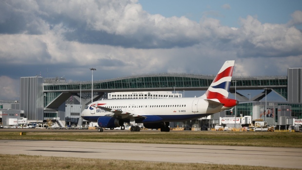 An Airbus SAS passenger aircraft operated by British Airways, a unit of International Consolidated Airlines Group SA (IAG), taxis on the tarmac at London Gatwick airport in Crawley, U.K., on Tuesday, Oct. 11, 2016. London Mayor Sadiq Khan urged U.K. Prime Minister Theresa May to decide quickly to build a new runway at the city's Gatwick Airport, saying it would show that the city is still open for business in the wake of the Brexit vote.