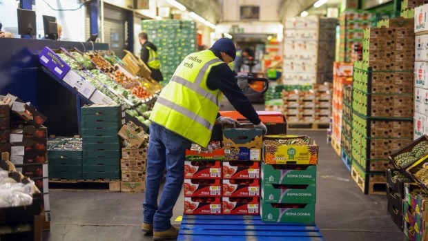 An employee loads boxes of fresh fruit on to a pallet in the Buyers Walk at New Covent Garden Market wholesale market in London, U.K., on Thursday, Sept. 30, 2021. As hauliers and retailers adapt to address some of the headline-grabbing food shortages, they're also pushing for government help. Photographer: Chris Ratcliffe/Bloomberg