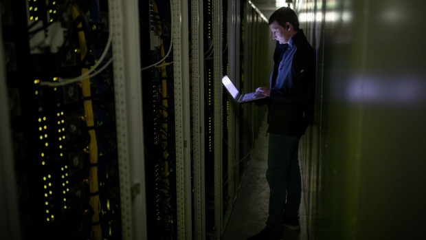 An employee of Northern Data Software GmbH, looks at data servers inside containers at the Lefdal Mine Datacenter in Maloy, Norway, on Tuesday, April 20, 2021. Based in the outskirts of Germany’s financial hub of Frankfurt, Northern Data operates high-performance computing centers in areas with cheap electricity. Photographer: Fredrik Solstad/Bloomberg