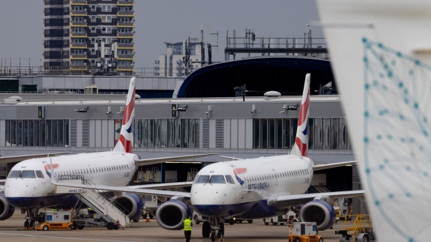 Two British Airways Plc passenger aircraft parked at gates at London City Airport Ltd. in London, U.K., on Monday, Sept. 20, 2021. London City Airport, a favorite of regional business travelers, is seeing a tentative reawakening as British Airways Plc and Deutsche Lufthansa AG restore flights to key financial centers. Photographer: Jason Alden/Bloomberg