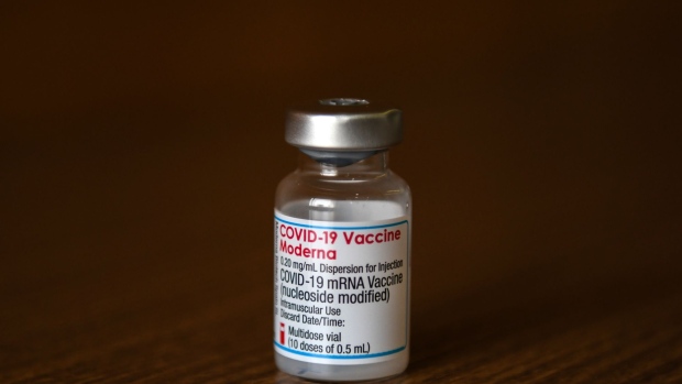 A bottle of the Moderna Inc. Covid-19 vaccine at a mass vaccination site in Saitama City, Saitama, Japan, on Monday, Aug. 23, 2021. Japan's Prime Minister Yoshihide Suga said last week that he expects 60% of the population to be fully vaccinated by the end of next month and plans to distribute enough doses to inoculate 80% of eligible people by early October. Photographer: Noriko Hayashi/Bloomberg