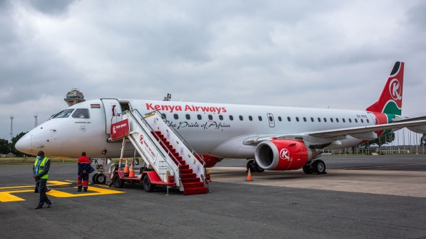 An Embraer SA 190 passenger aircraft, operated by Kenya Airways Ltd., stands on the tarmac during a reopening ceremony at Jomo Kenyatta International Airport in Nairobi, Kenya, on Wednesday, July 15, 2020. Kenya Airways Plc started a three-month round of job cuts as lawmakers debate a bill to nationalize the carrier and its losses mount due to the impact of the coronavirus pandemic. Photographer: Patrick Meinhardt/Bloomberg