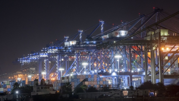 Shipping containers at night at the Port of Los Angeles in Los Angeles, California, U.S., on Wednesday, Oct. 13, 2021. President Joe Biden turned his focus to supply-chain transportation bottlenecks on Wednesday, announcing that the congested Port of Los Angeles would begin operating 24 hours a day and seven days a week, and that retailers had pledged to step up efforts to move goods. Photographer: Kyle Grillot/Bloomberg