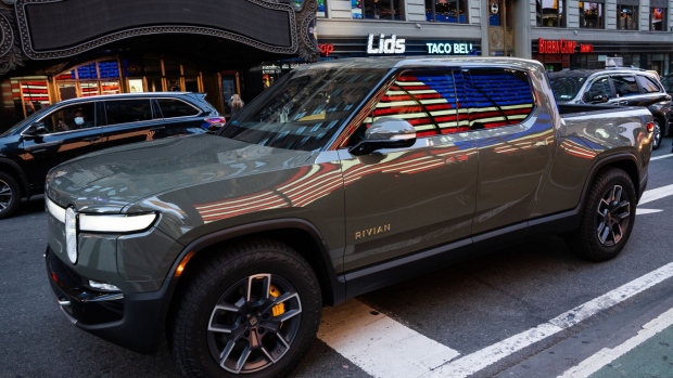 A Rivian R1T electric pickup truck during the company's IPO outside the Nasdaq MarketSite in New York, U.S., on Wednesday, Nov. 10, 2021. Electric vehicle-maker Rivian Automotive Inc. priced shares in its initial public offering at $78 apiece to raise about $11.9 billion, the biggest first-time share sale this year. Photographer: Bing Guan/Bloomberg