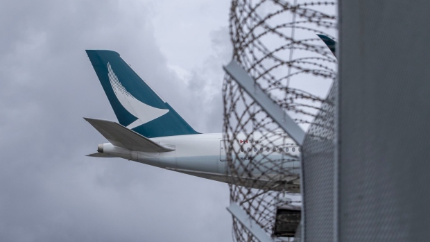 An aircraft operated by Cathay Pacific Airways Ltd. approaches Hong Kong International Airport in Hong Kong, China, on Tuesday, Aug. 10, 2021. Cathay is scheduled to report half-year results on Aug. 11. Photographer: Paul Yeung/Bloomberg
