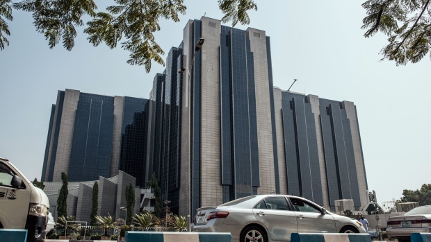 Automobiles drive past the headquarters of the Nigerian central bank in Abuja, Nigeria, on Friday, Jan. 10, 2020. Revenue in Nigeria has fallen short of the government target by at least 45% every year since 2015, and shortfalls have been funded through increased borrowing. Photographer: KC Nwakalor/Bloomberg