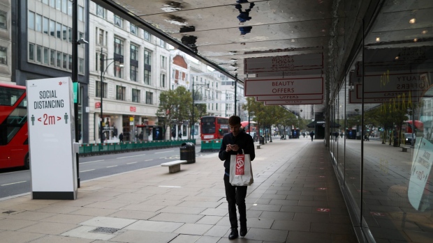A pedestrian walks along Oxford Street in London, U.K., on Thursday, Nov. 5, 2020. The Bank of England boosted its bond-buying program by a bigger-than-expected 150 billion pounds ($195 billion) in another round of stimulus to help the economy through a second wave of coronavirus restrictions. Photographer: Chris Ratcliffe/Bloomberg