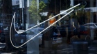 The Nike Inc. logo is displayed in the window of the Nike by Melrose live concept store in West Hollywood, California, U.S., on Monday, July 30, 2018. The return to growth in the U.S., a market that has been challenged for over a year, is a testament to the strength of Nike's recent product pipeline, which is driving an improved sales outlook for fiscal 2019. Photographer: Patrick T. Fallon/Bloomberg