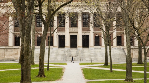 A pedestrian walks through Harvard Yard on the closed Harvard University campus in Cambridge, Massachusetts, U.S., on Monday, April 20, 2020. College financial aid offices are bracing for a spike in appeals from students finding that the aid packages they were offered for next year are no longer enough after the coronavirus pandemic cost their parents jobs or income. Photographer: Adam Glanzman/Bloomberg